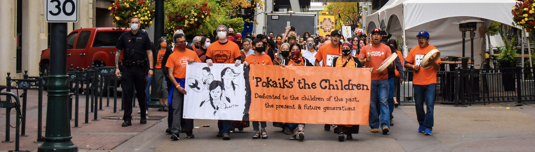 People walking at Pokaiks – The Children: Orange Shirt Day event, 2021.