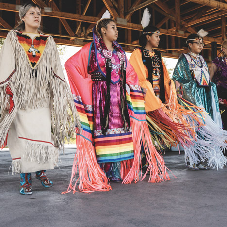 Photo of Mini Thni Dancers performing at an event in Cochrane that was held in lieu of Canada Day celebrations